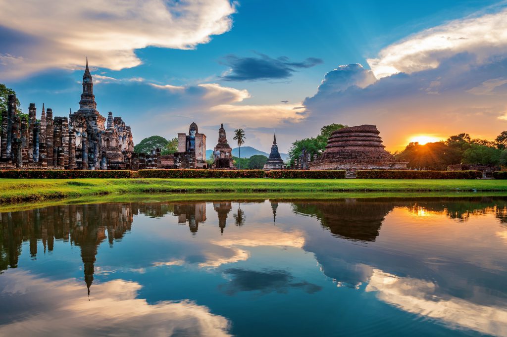 Buddha statue and Wat Mahathat Temple in the precinct of Sukhoth