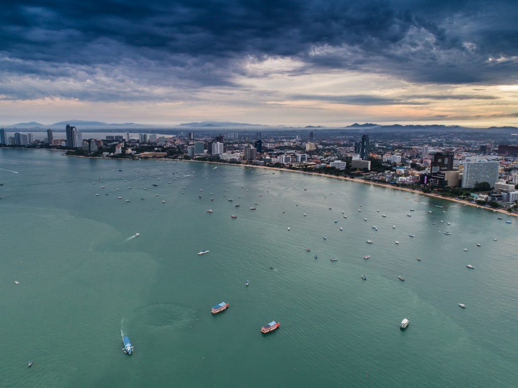 Aerial view of Pattaya beach as the sun rises over the ocean.